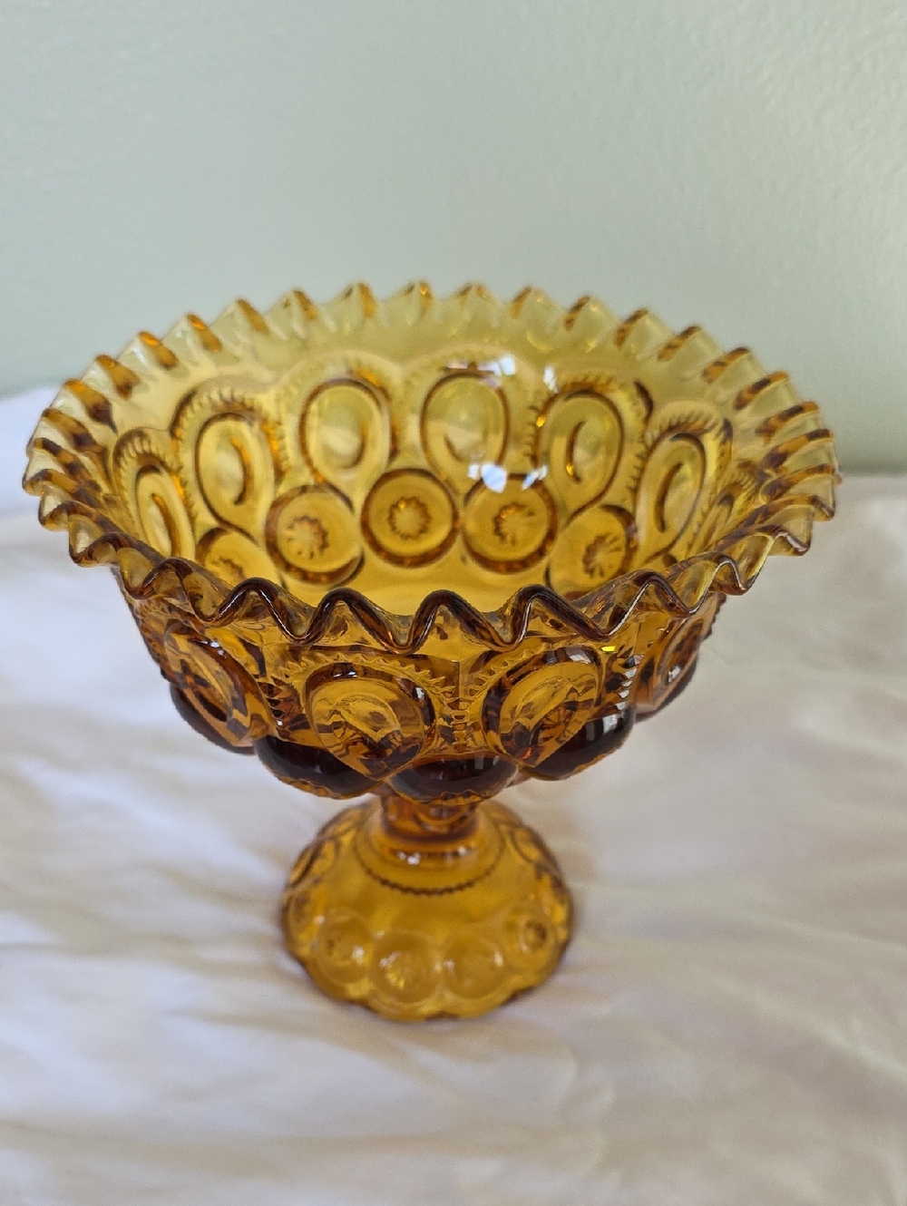 Amber glass Vintage pedestal bowl in L.E. Smith's Moon and Stars pattern.